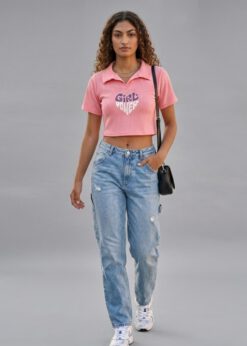 Peach Girl Power Crop Polo shirt worn by a model with high-waisted denim jeans