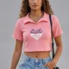 Peach Girl Power Crop Polo shirt worn by a model with high-waisted denim jeans