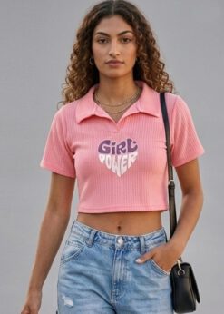 Peach Girl Power Crop Polo shirt worn by a model with high-waisted denim jeans